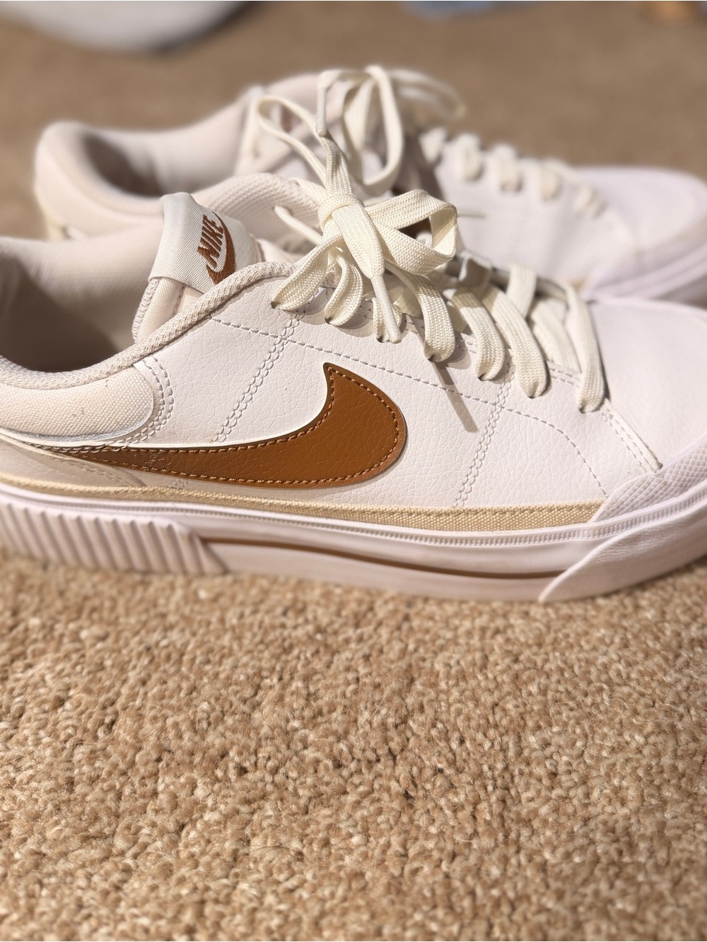 Nike Women’s Low-Top Sneakers in White with Brown Swoosh
